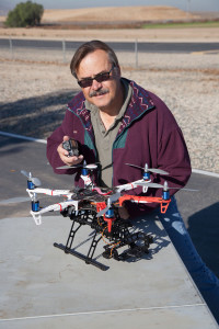 Here the author is  detting ready to do some aerial photography by attaching a GoPro camera to the front of this DJI Flamewheel 550.