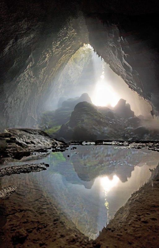 Vertical panorama from below the stalagmites, which are located below the first limestone depression. The sun is shining through the opening over 1,000 feet above. 