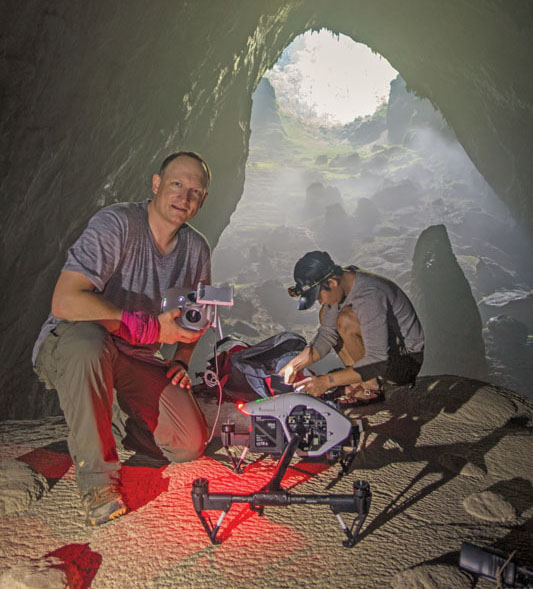  The author and an Oxalis Adventure porter set up the DJI Inspire 1 for a flight below the second limestone depression inside Son Doong. 